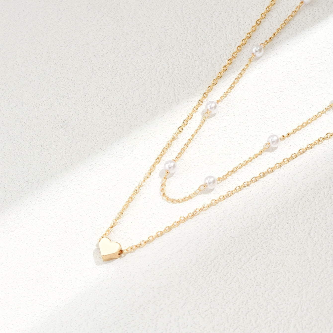 Meliora | Women's delicate pearl necklace with heart pendant | Gold