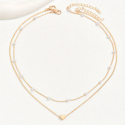 Meliora | Women's delicate pearl necklace with heart pendant | Gold