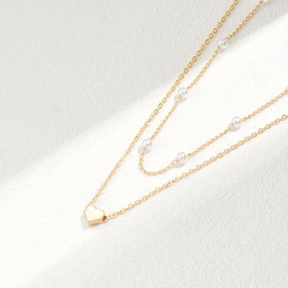 Meliora | Women's delicate pearl necklace with heart pendant | Gold