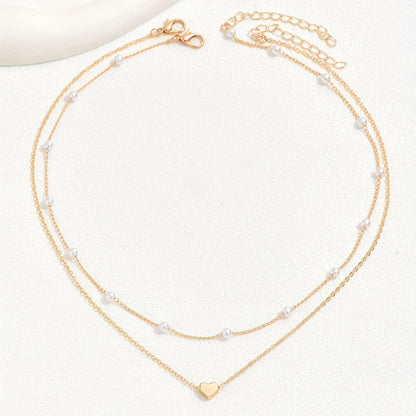 Meliora | Women's delicate pearl necklace with heart pendant | Gold